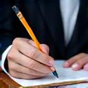 A consultant taking notes during a meeting with a client.