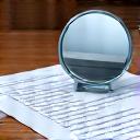 A checklist with a magnifying glass over it.